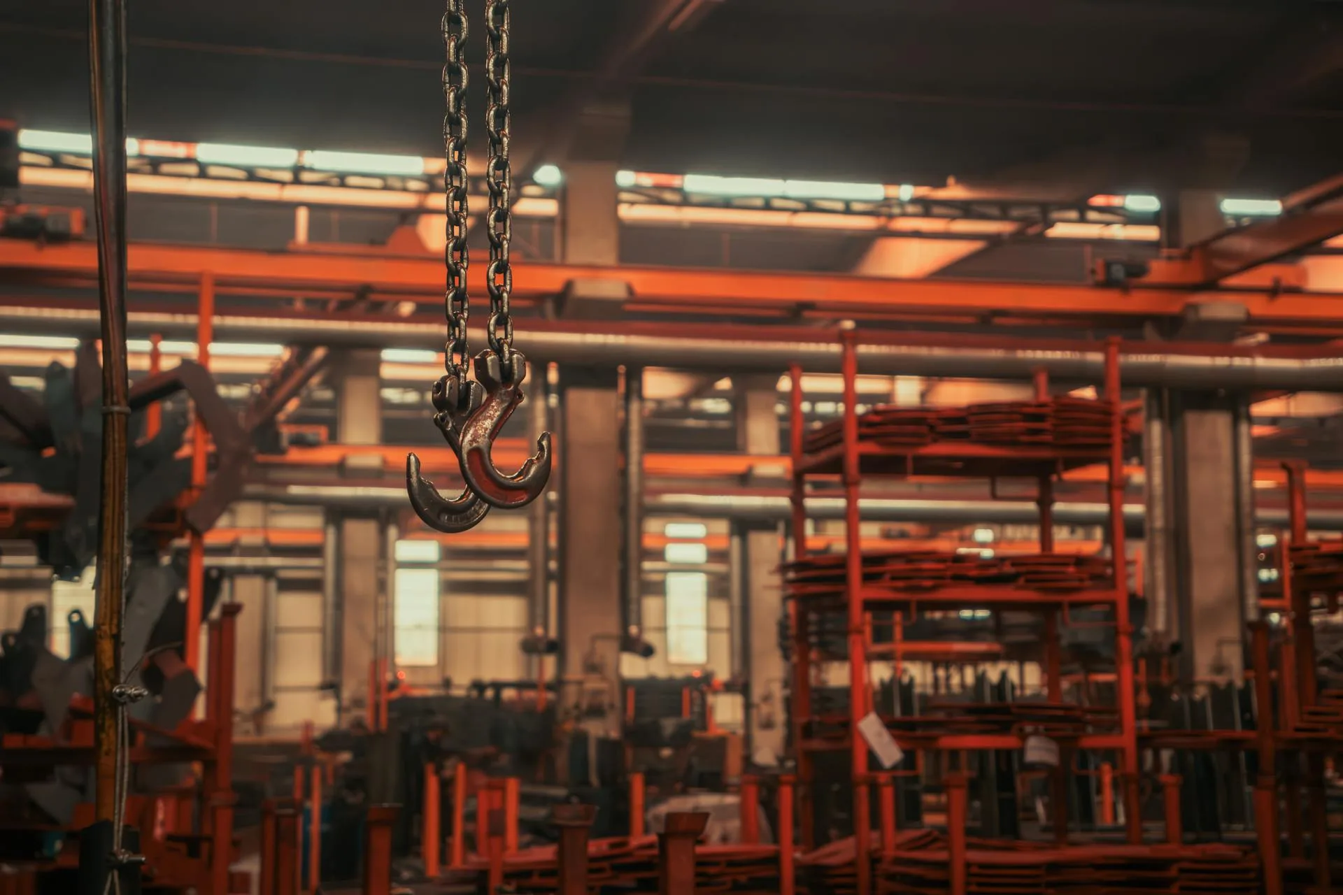 Overhead crane hooks in industrial warehouse