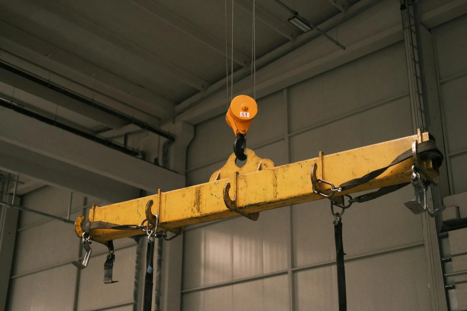 Yellow industrial crane in manufacturing facility